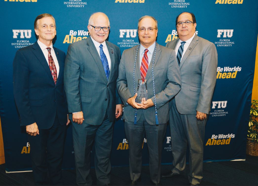 Frank Mora receives the award in name of LACC